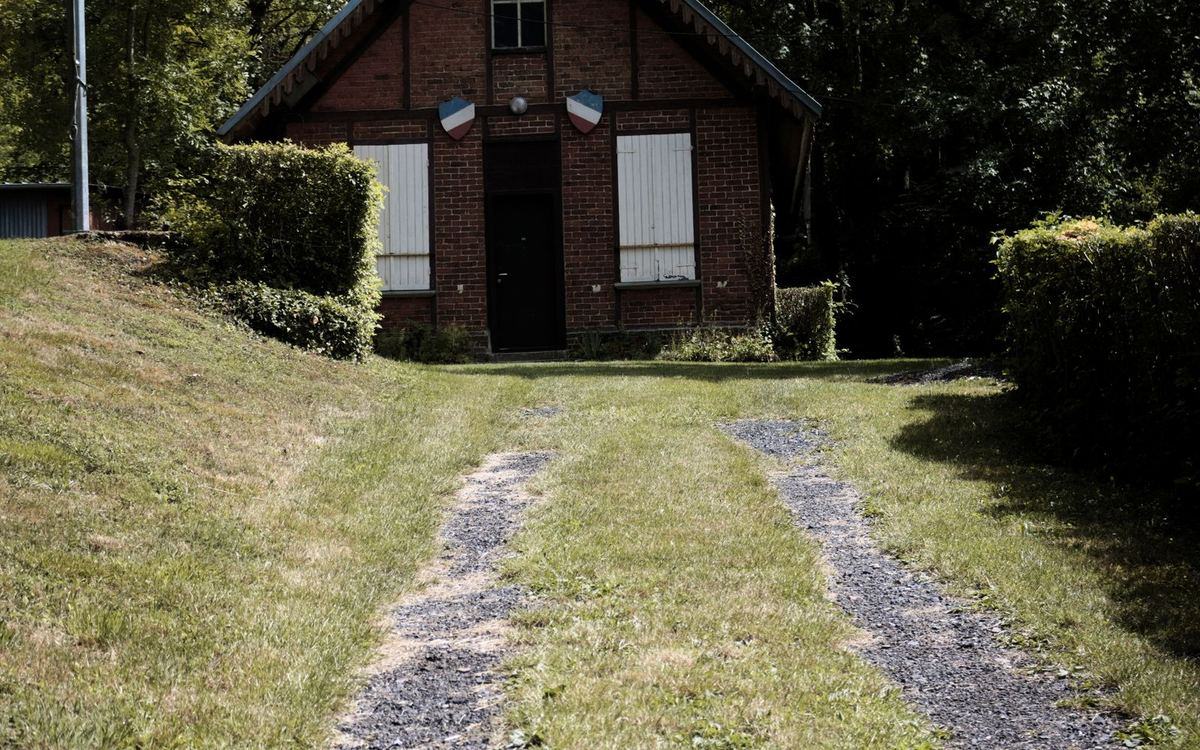 Gravel driveway leading to a rural property
